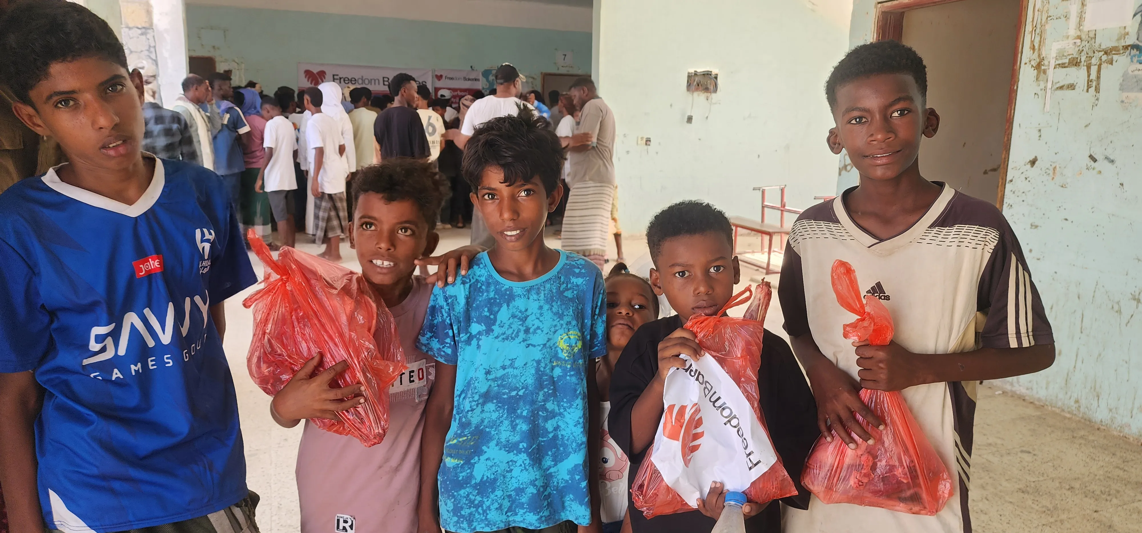 Children receiving Qurbani packages
