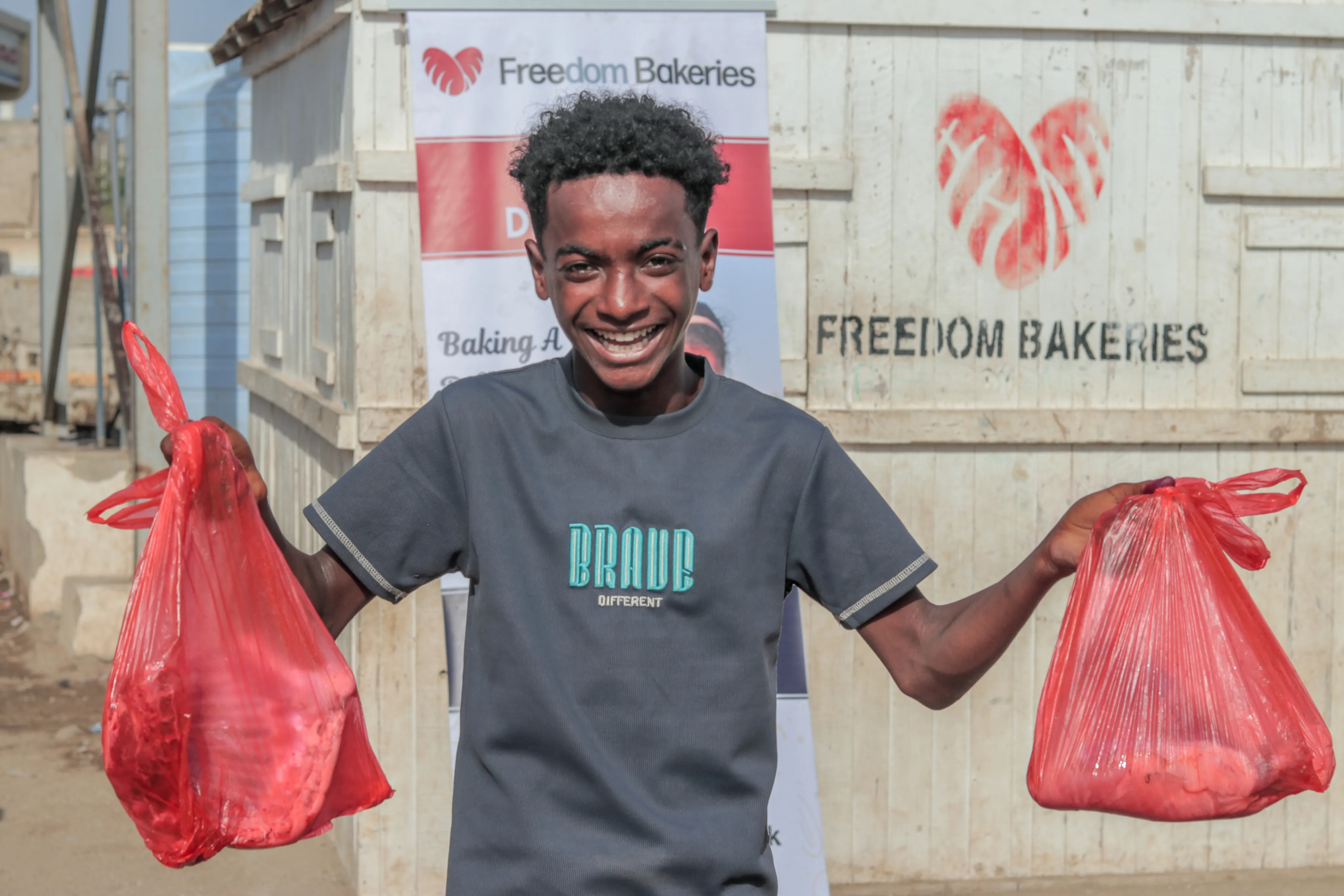 Boy holding Qurbani food packages